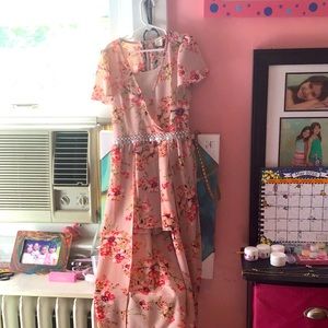 This is a Monteau Girl romper that has floral design and a cute waist strap.